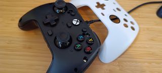 A GameSir G7 Xbox controller with a swappable faceplate sitting on a wooden desk