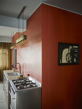 red kitchen with freestanding style, no wall units, row of pendants