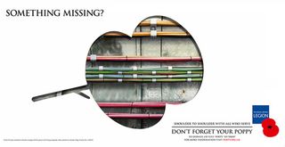 The Poppy Appeal campaign features three print ads with a cut-out poppy revealing, in this case, mechanics of the London tube. Image © Taylor James
