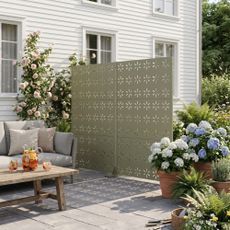 Privacy screens from Target's new range on a patio in a modern garden bringing shade as well as privacy
