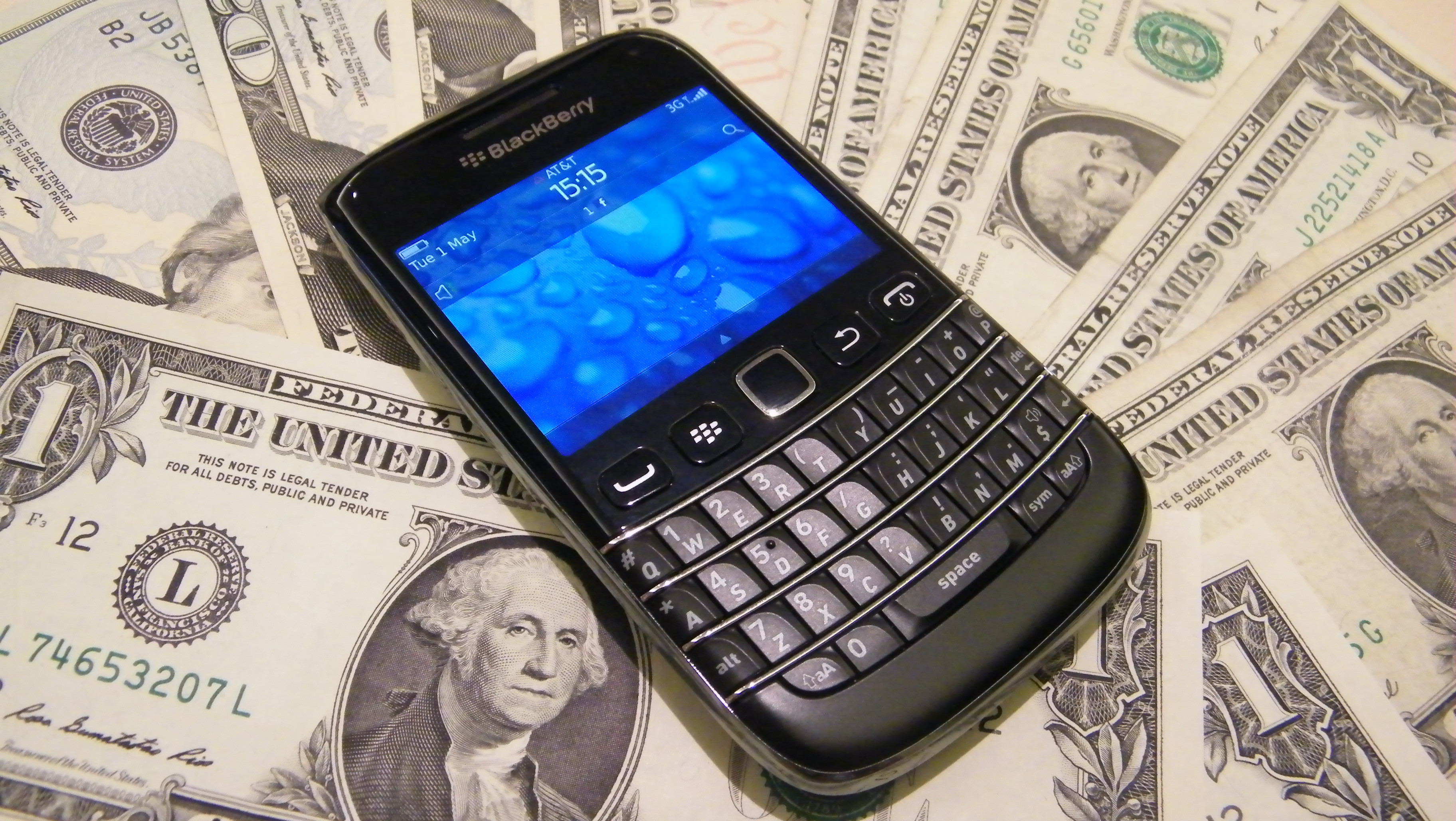 A BlackBerry phone lying on money