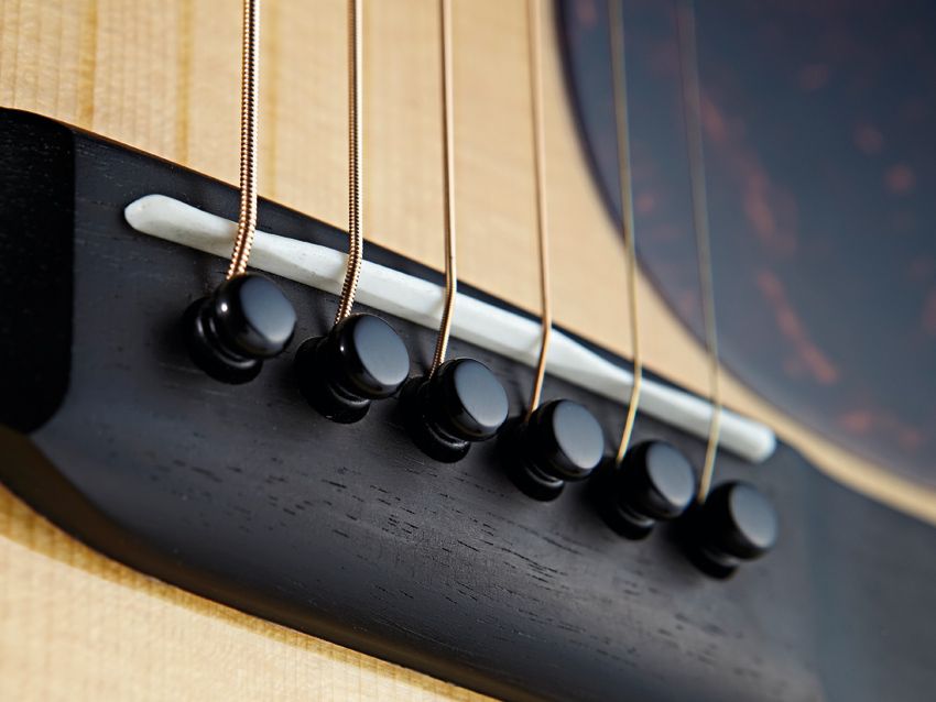 The D-18 comes finished with all-black bridge pins.