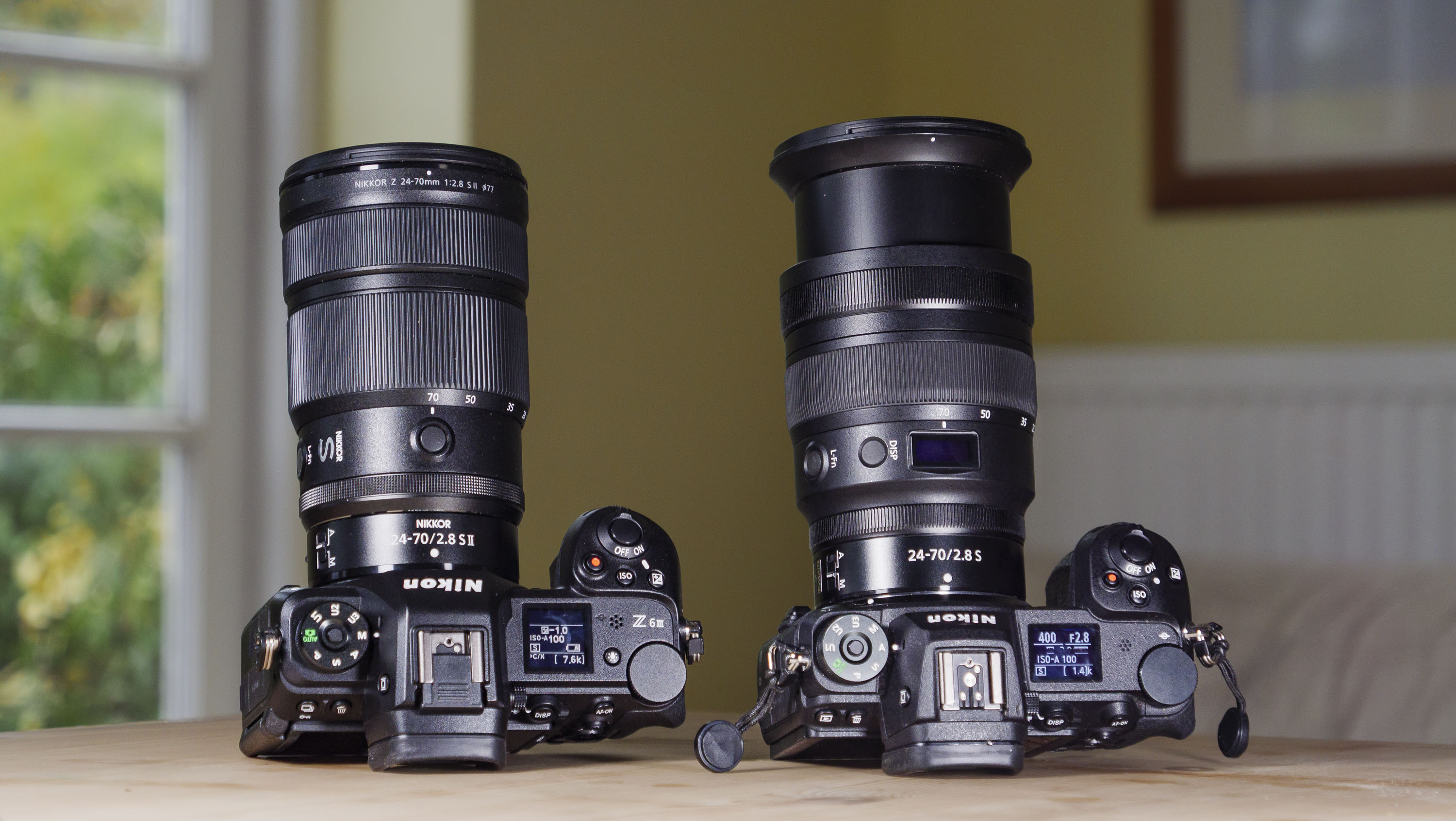 Nikon Z 24-70mm f/2.8 S II lens mounted to a Nikon Z6 III, alongside Nikon Z 24-70mm f/2.8 S lens attached to a Nikon Z6 II