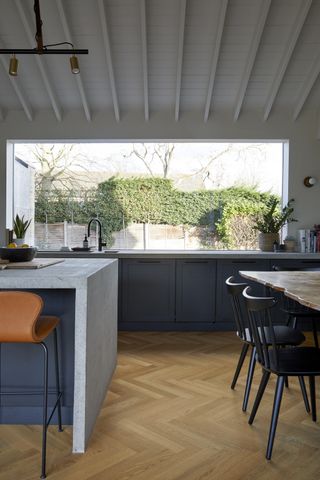 A kitchen with a concrete counter