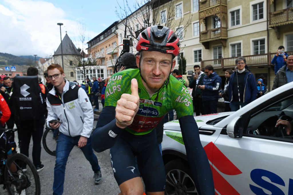 BRUNICO ITALY APRIL 21 Tao Geoghegan Hart of United Kingdom and Team INEOS Grenadiers Green Leader Jersey celebrates at finish line as final overall winner after the 46th Tour of the Alps 2023 Stage 5 a 1445km stage from Cavalese to Brunico on April 21 2023 in Brunico Italy Photo by Tim de WaeleGetty Images