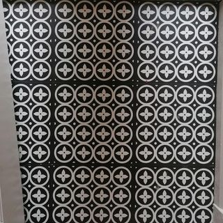 hallway with black and white pattern flooring