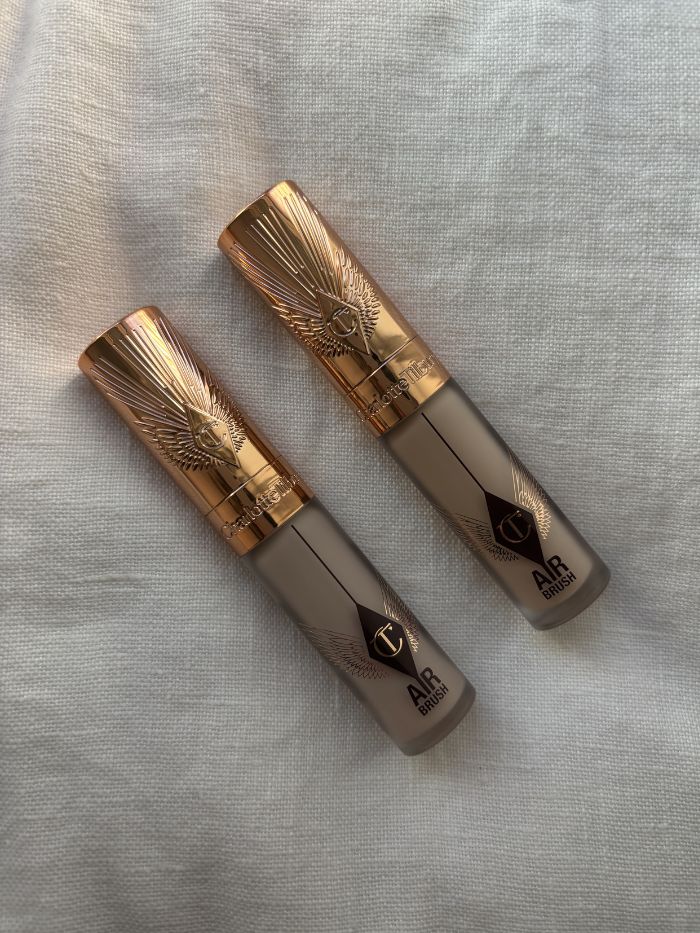 The Charlotte Tilbury Airbrush Flawless Blur Concealer on a white linen background