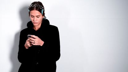 model looking at her phone - prime day beauty deals