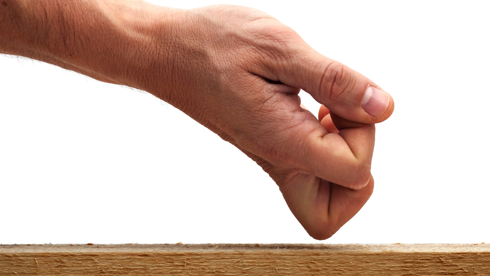 A man's knuckle knocks on wood.