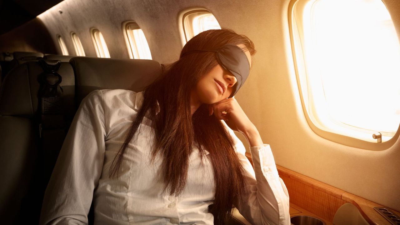 woman sleeping on plane