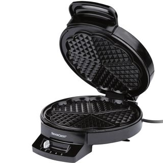 black coloured heart shaped waffle maker with white background