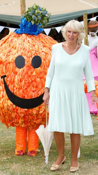 Queen Camilla with someone in a Mr Tickle costume