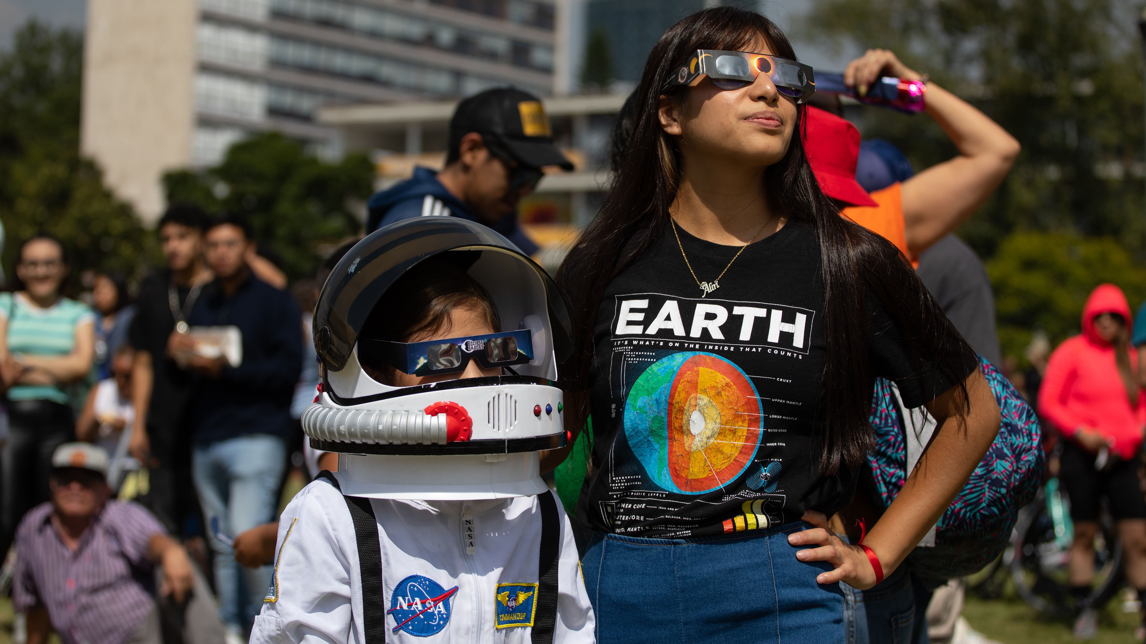 : People observe the Annular Solar Eclipse with using safety glasses at the facilities of the National Autonomous University of Mexico (UNAM) in Mexico City, Mexico on October 14, 2023. (