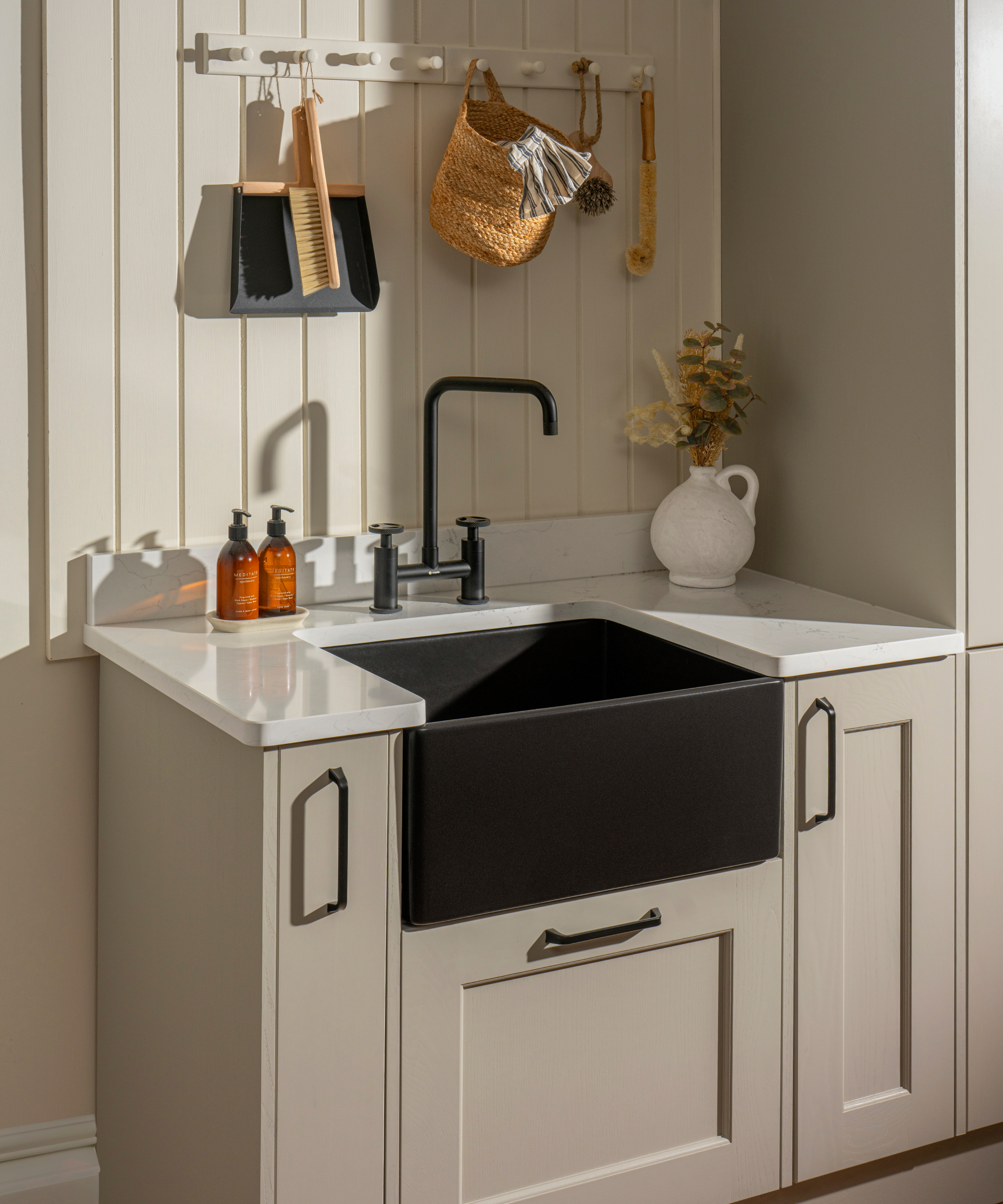 black modern belfast sink in utility room