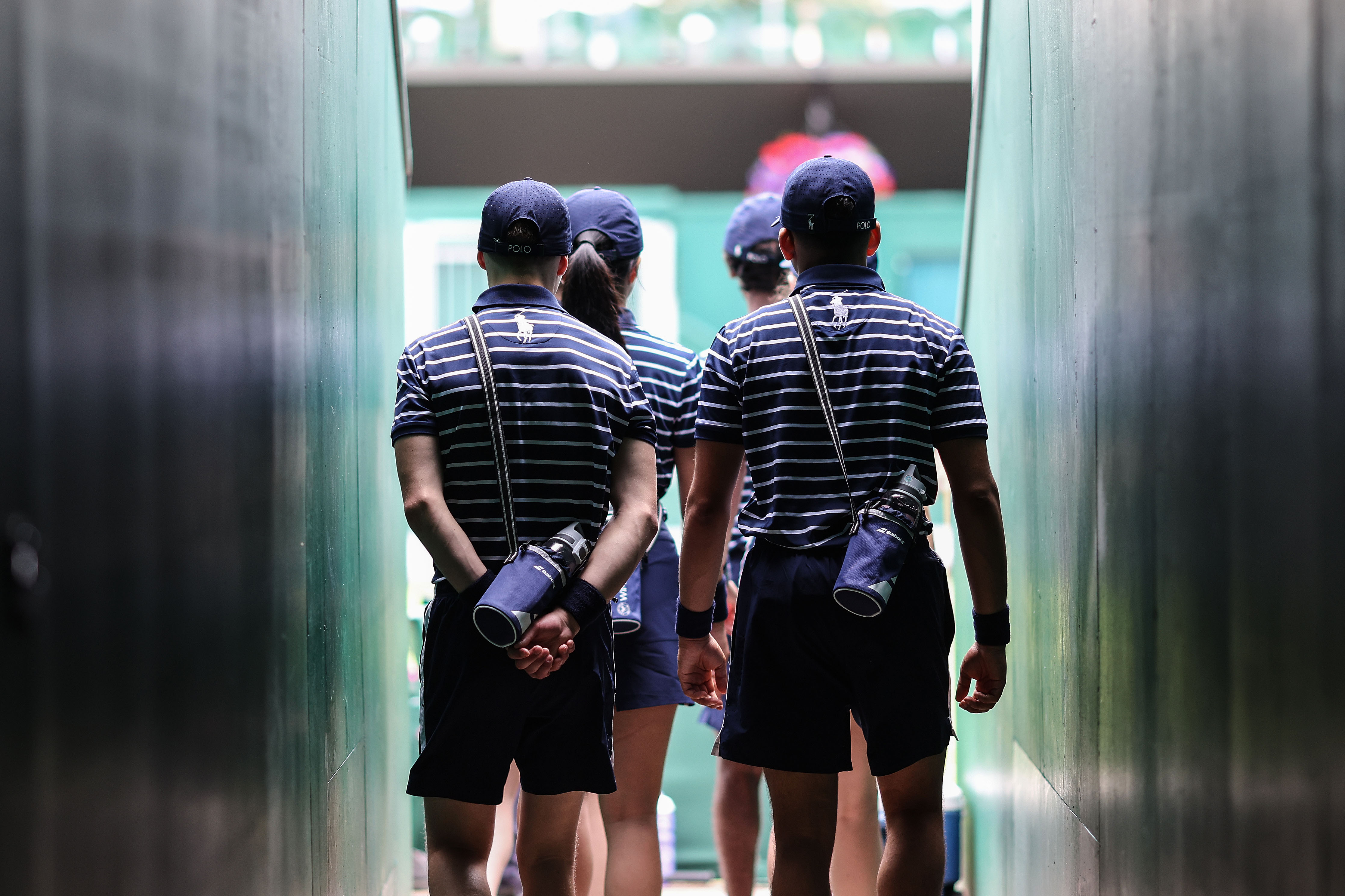 Wimbledon ball boys and girls queueing to enter the court