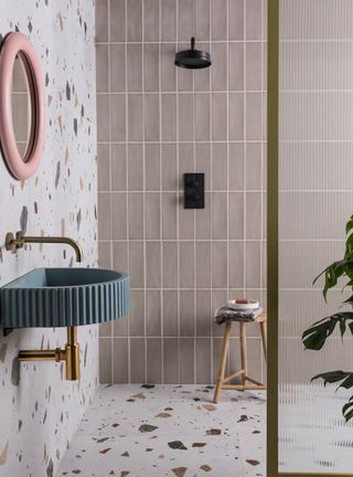 Terrazzo bathroom with pink tiles and blue basin