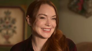 Lindsay Lohan smiling in the Falling For Christmas trailer. 