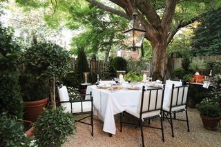 patio with dining table and large tree