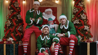 Paul Campbell, Tyler Hynes, and Andrew Walker dressed up as elves with Santa and a baby in Three Wise Men and A Baby