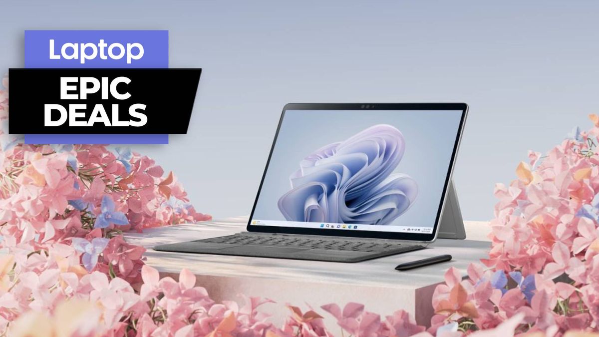 Microsoft Surface Pro 9 with keyboard attached and pen on a wooden table surrounded by flowers against a sky blue background