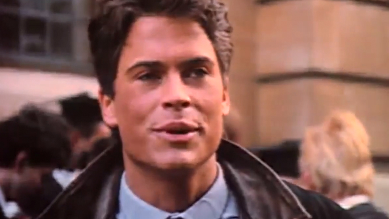 A close up of Rob Lowe smiling in Oxford Blues