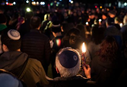 Members and supporters of the Jewish community come together for a candlelight vigil, in remembrance of those who died earlier in the day during a shooting at the Tree of Life Synagogue.