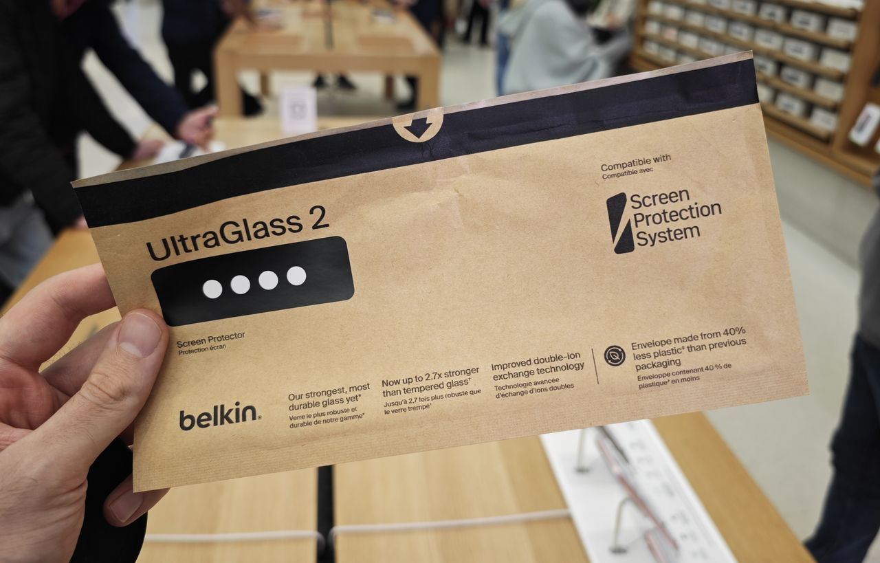The Belkin UltraGlass screen protector being applied to the iPhone 15 Pro Max
