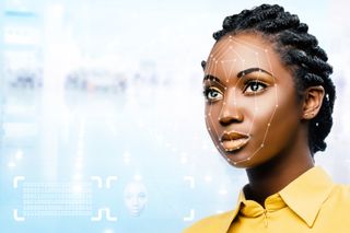 A woman&amp;#039;s face being scanned by facial recognition technology