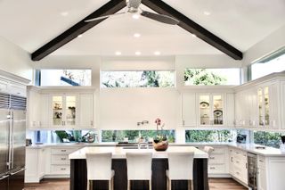 Modern, white kitchen with window backsplash