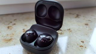 The Samsung Galaxy Buds Pro in their charging case on a marble surface.