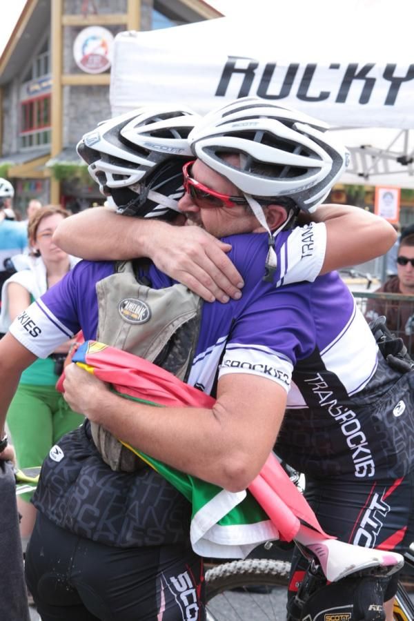 Two teammates hug after seven days of racing together.