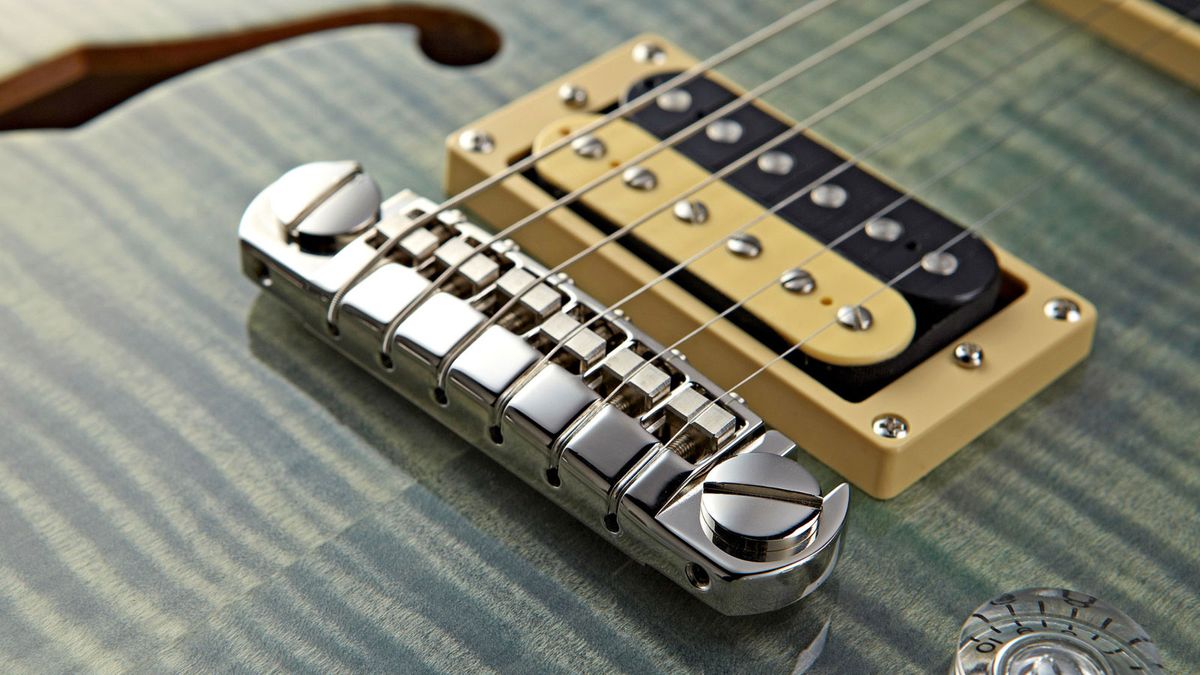 Usually PRS SE guitars use replicas of the USA parts, made in Korea. But this wrapover bridge is almost identical to the USA one, which retails at $290!