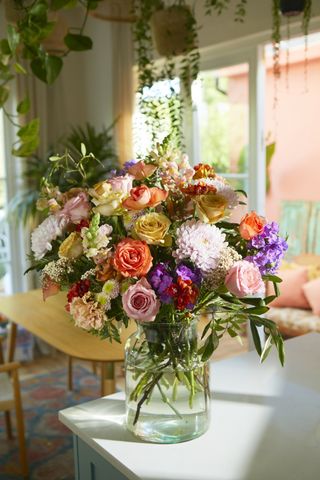 lush bouquet of flowers in a vase in a kitchen
