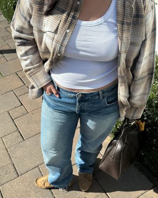 woman wearing white tank with jeans and loafers spring outfit