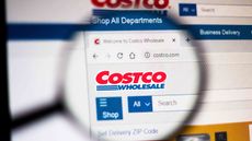 In this photo illustration the homepage of the Costco Wholesale Corporation website is seen displayed on a computer screen through a magnifying glass.