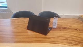 black chromebook on wooden desk