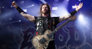 Gary Holt with arms out wide as Exodus play Alcatraz Metal Fest, Belgium. He plays his signature ESP single-cut.
