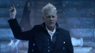 Johnny Depp stands with his wand raised in Fantastic Beasts: The Crimes Of Grindelwald.