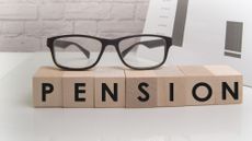Glasses on top of blocks spelling pension