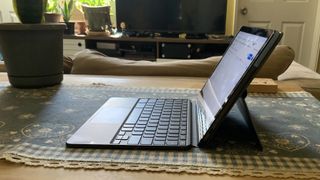 En åpen Lenovo Duet Chromebook sett fra siden i en oppholdsrom.