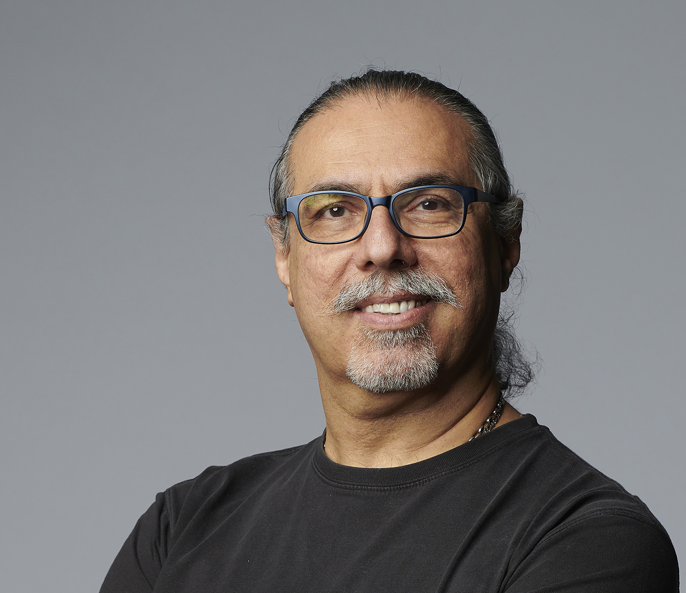 Vetere Acoustics owner Touraj Moghaddam on a grey background