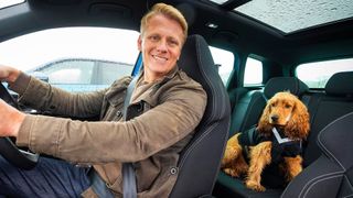 Mango in the back of Skoda electric car with Dr Scott Miller in front seat