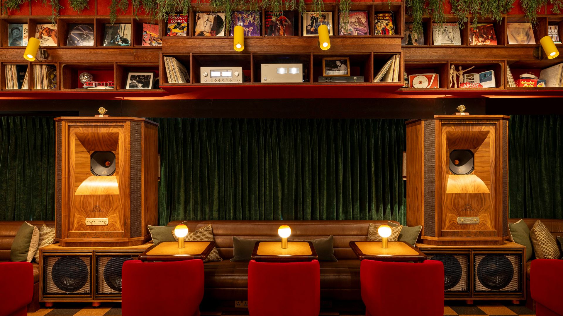 an image of the inner of the bar which shows hte tables, booths, and speakers