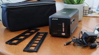 best film scanner Plustek Opticfilm 8200i SE and accessories on a wooden table