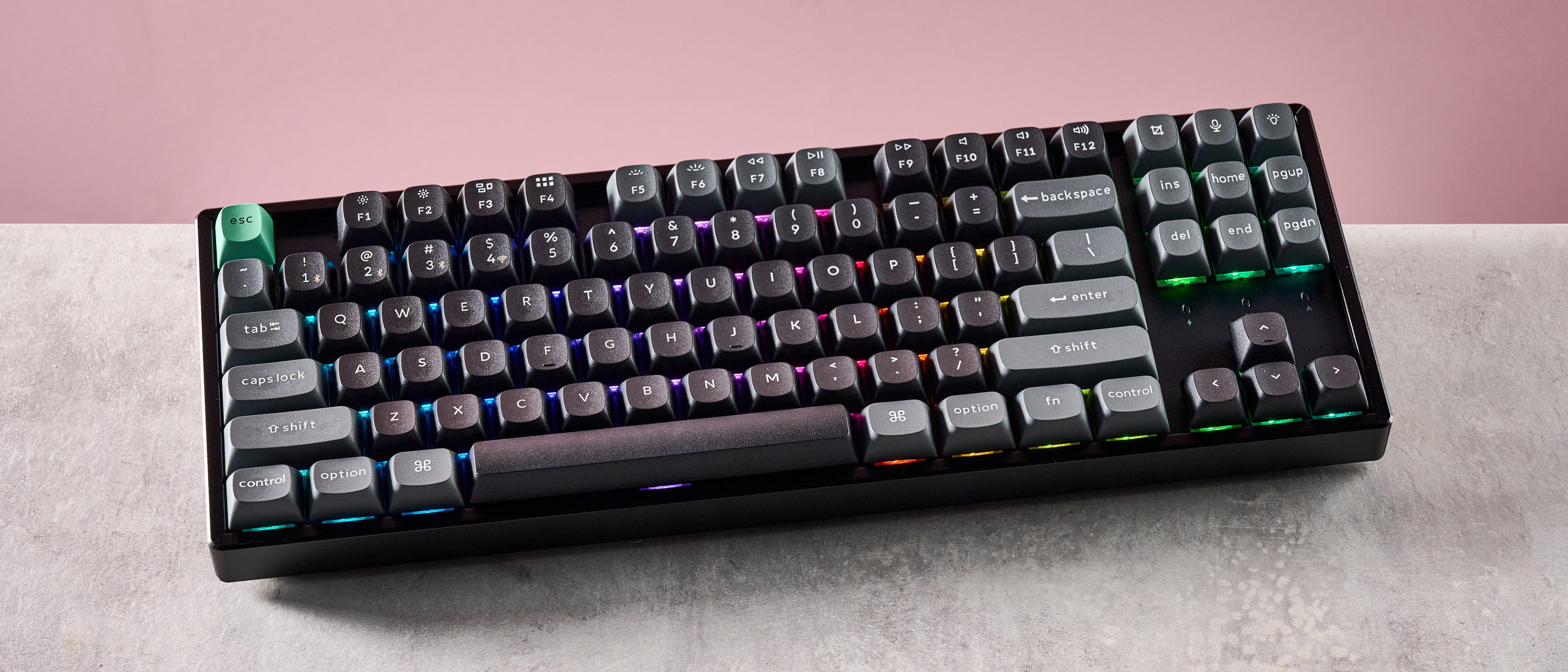 Top-down view of Keychron K8 Ultra 8K on desk with pink wall in background
