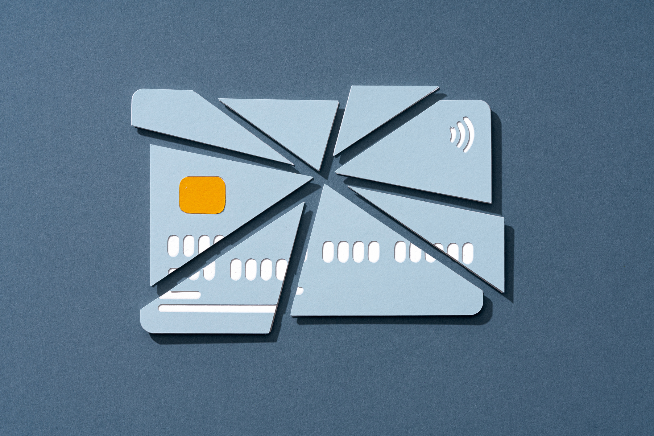 Paper Craft of Cracked Credit Card on Blue Background Front View.