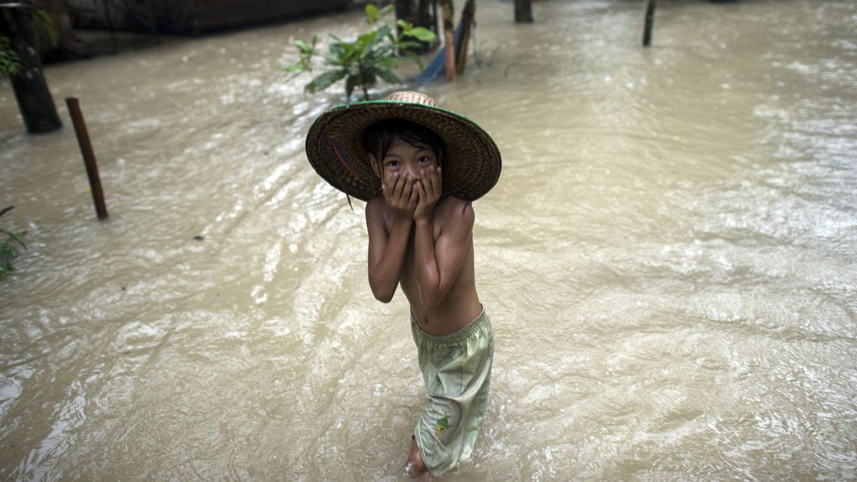 A child walks through floodwaters in Kyangyi Dauk village in Myanmar's Irrawaddy region