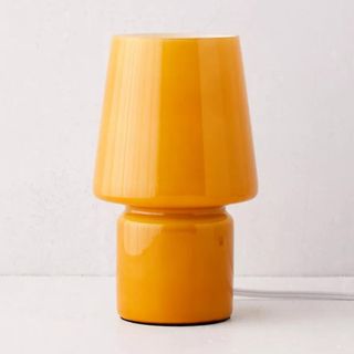 An orange mushroom-style glass lamp