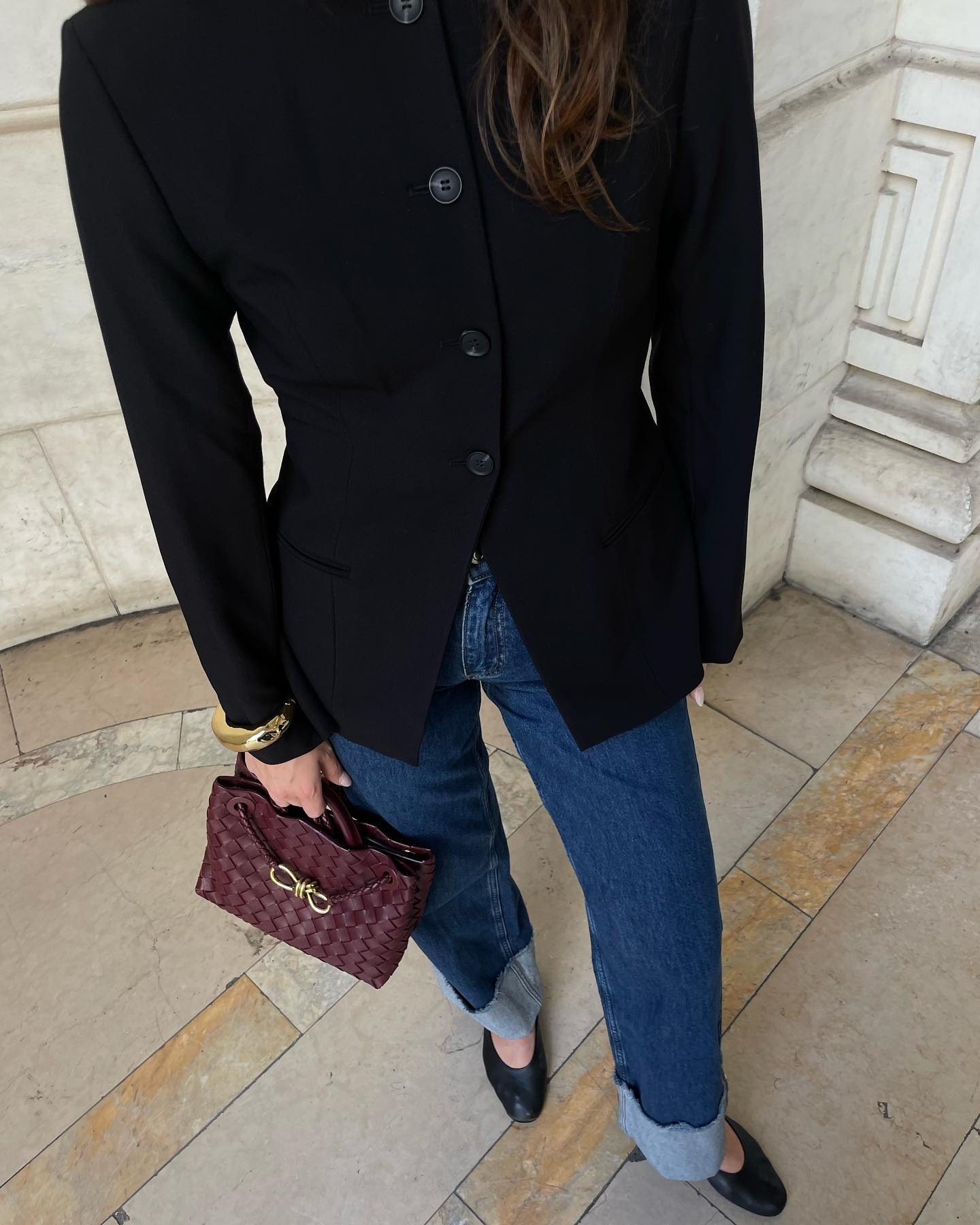 anna laplaca wears black aligne blazer jeans and burgundy bottega bag
