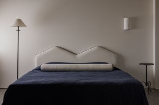 A bolster on the head of a bed